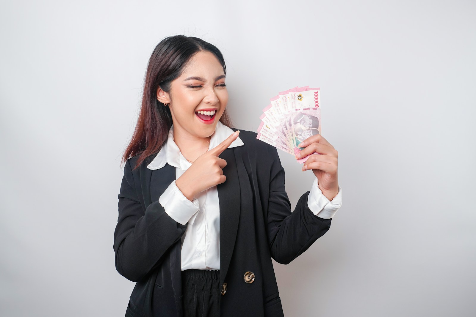 a woman holding a bunch of money in her hands